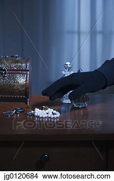 Stock Photo - thief reaching 
for a string of 
pearls. fotosearch 
- search stock 
photos, pictures, 
images, and photo 
clipart