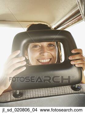 Stock Photo - woman smiling 
from front seat 
of car. fotosearch 
- search stock 
photos, pictures, 
images, and photo 
clipart