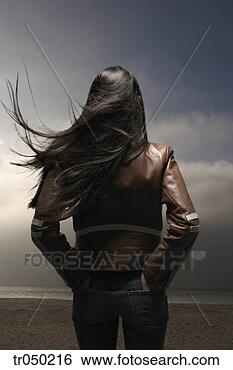 Stock Photo - woman standing 
on windy beach. 
fotosearch - search 
stock photos, 
pictures, images, 
and photo clipart
