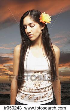 Stock Photo - woman wearing 
a flower in her 
hair. fotosearch 
- search stock 
photos, pictures, 
images, and photo 
clipart
