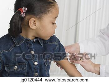 Stock Photo - young girl getting 
a shot. fotosearch 
- search stock 
photos, pictures, 
images, and photo 
clipart