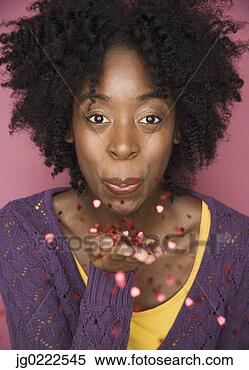 Stock Image - young woman blowing 
confetti. fotosearch 
- search stock 
photos, pictures, 
images, and photo 
clipart