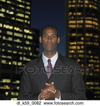 Stock Photo - african businessman 
in front of urban 
buildings at night, 
 perth. fotosearch 
- search stock 
photos, pictures, 
images, and photo 
clipart