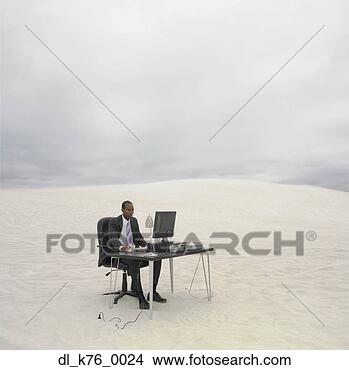 Stock Photo - african businessman 
sitting at desk 
in the desert, 
lancelin, australia. 
fotosearch - search 
stock photos, 
pictures, images, 
and photo clipart