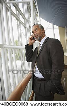 Stock Photo - african businessman 
talking on cell 
phone next to 
window,  north. 
fotosearch - search 
stock photos, 
pictures, images, 
and photo clipart