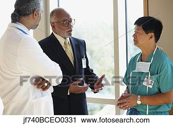 Stock Photography - african businessman 
talking to male 
asian surgeon 
and male african. 
fotosearch - search 
stock photos, 
pictures, images, 
and photo clipart