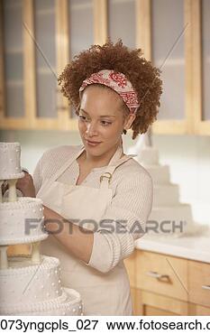 Picture - african female 
baker decorating 
a wedding cake, 
 richmond,  virginia. 
fotosearch - search 
stock photos, 
pictures, images, 
and photo clipart
