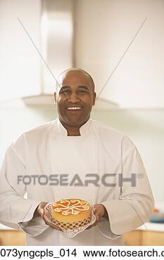 Stock Photo - african male pastry 
chef holding a 
cake,  richmond, 
 virginia. fotosearch 
- search stock 
photos, pictures, 
images, and photo 
clipart