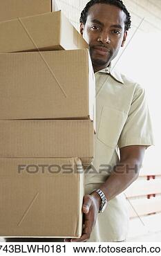 Stock Photography - african man carrying 
boxes. fotosearch 
- search stock 
photos, pictures, 
images, and photo 
clipart