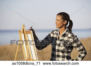 Stock Photography - african woman 
painting at an 
easel outdoors, 
 eastville,  virginia. 
fotosearch - search 
stock photos, 
pictures, images, 
and photo clipart