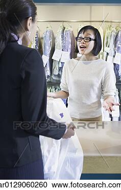 Stock Photography - asian drycleaner 
talking to customer, 
 edmonds,  washington, 
 united. fotosearch 
- search stock 
photos, pictures, 
images, and photo 
clipart