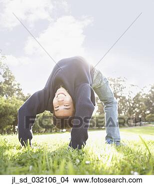 Stock Photo - asian man doing 
a back bend in 
the sunlight, 
 ocean beach, 
 san. fotosearch 
- search stock 
photos, pictures, 
images, and photo 
clipart