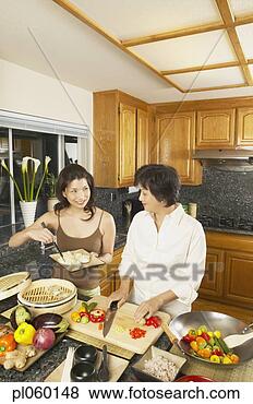 Stock Photo - asian mother and 
grown daughter 
preparing dinner, 
 freemont. fotosearch 
- search stock 
photos, pictures, 
images, and photo 
clipart