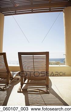 Stock Photo - balcony with lounge 
chairs at resort 
hotel, los cabos, 
mexico. fotosearch 
- search stock 
photos, pictures, 
images, and photo 
clipart