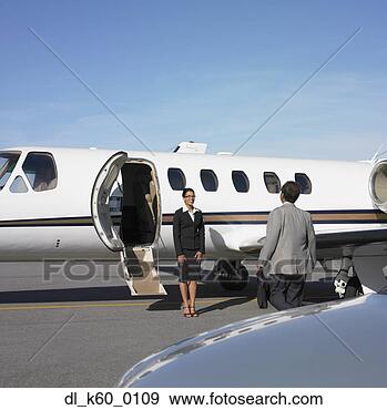 Stock Photograph - businessman being 
greeted by flight 
attendant at airplane, 
 perth. fotosearch 
- search stock 
photos, pictures, 
images, and photo 
clipart