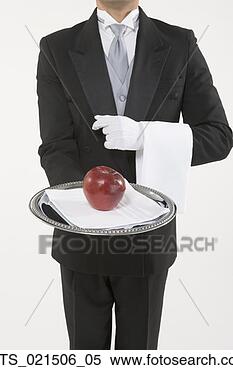 Stock Image - butler holding 
a silver tray 
with an apple. 
fotosearch - search 
stock photos, 
pictures, images, 
and photo clipart