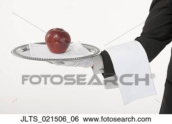 Stock Photo - butler holding 
a silver tray 
with an apple. 
fotosearch - search 
stock photos, 
pictures, images, 
and photo clipart