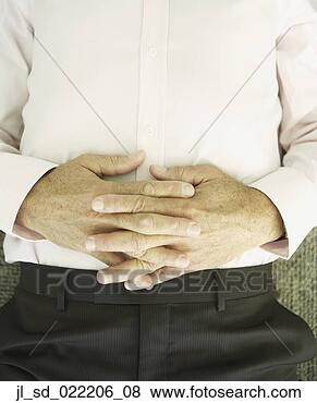 Stock Photo - close up of man's 
hand clasped on 
his stomach. fotosearch 
- search stock 
photos, pictures, 
images, and photo 
clipart