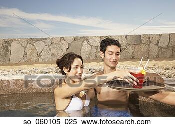 Stock Image - couple being served 
drinks in a resort 
pool, los cabos, 
mexico. fotosearch 
- search stock 
photos, pictures, 
images, and photo 
clipart