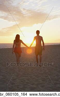 Stock Photo - couple holding 
hands on the beach 
at sunset, los 
cabos, mexico. 
fotosearch - search 
stock photos, 
pictures, images, 
and photo clipart
