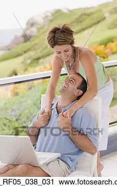 Stock Photography - couple hugging 
on balcony, florianopolis, 
brazil. fotosearch 
- search stock 
photos, pictures, 
images, and photo 
clipart