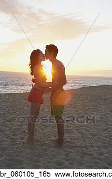 Stock Image - couple kissing 
on the beach at 
sunset, los cabos, 
mexico. fotosearch 
- search stock 
photos, pictures, 
images, and photo 
clipart