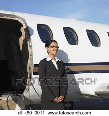 Stock Photography - female flight 
attendant standing 
next to airplane, 
perth, australia. 
fotosearch - search 
stock photos, 
pictures, images, 
and photo clipart