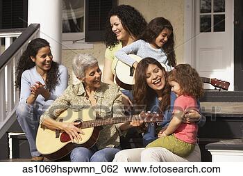 Stock Photo - female hispanic 
family members 
sitting on the 
porch playing 
guitar. fotosearch 
- search stock 
photos, pictures, 
images, and photo 
clipart