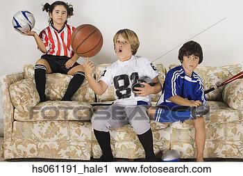 Stock Photography - group of children 
in sports gear 
on the sofa. fotosearch 
- search stock 
photos, pictures, 
images, and photo 
clipart