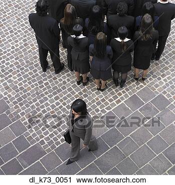 Stock Photography - high angle view 
of businesswoman 
walking past group 
of businesspeople. 
fotosearch - search 
stock photos, 
pictures, images, 
and photo clipart