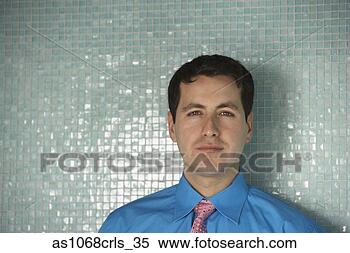 Stock Image - hispanic businessman 
standing in front 
of tiled wall, 
 richmond. fotosearch 
- search stock 
photos, pictures, 
images, and photo 
clipart