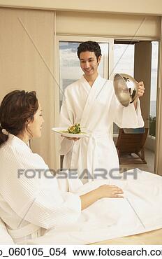 Stock Photo - hispanic couple 
with food in hotel 
room, los cabos, 
mexico. fotosearch 
- search stock 
photos, pictures, 
images, and photo 
clipart