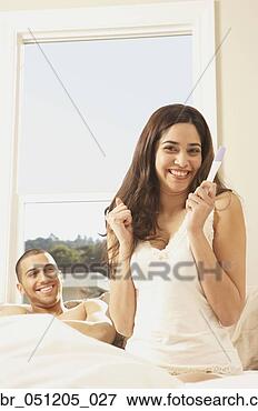 Picture - hispanic couple 
with pregnancy 
test looking happy, 
 san rafael. fotosearch 
- search stock 
photos, pictures, 
images, and photo 
clipart