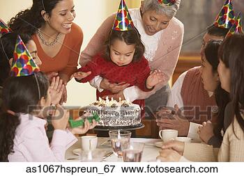 Picture - hispanic girl 
blowing out her 
birthday candles, 
 richmond,  virginia. 
fotosearch - search 
stock photos, 
pictures, images, 
and photo clipart