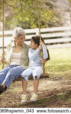 Stock Photo - hispanic grandmother 
and granddaughter 
sitting on a swing, 
 richmond. fotosearch 
- search stock 
photos, pictures, 
images, and photo 
clipart