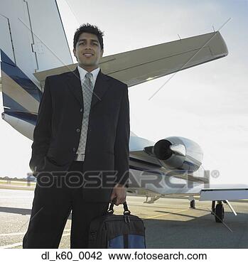 Stock Photo - indian businessman 
standing next 
to airplane, perth, 
australia. fotosearch 
- search stock 
photos, pictures, 
images, and photo 
clipart