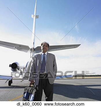 Stock Photography - indian businessman 
standing next 
to airplane, perth, 
australia. fotosearch 
- search stock 
photos, pictures, 
images, and photo 
clipart