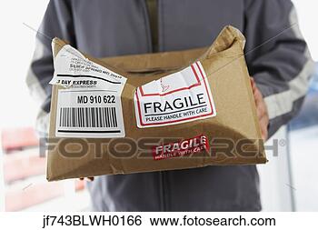 Stock Photo - man holding crushed 
package marked 
fragile. fotosearch 
- search stock 
photos, pictures, 
images, and photo 
clipart
