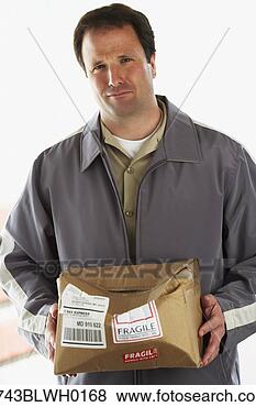 Stock Photo - man holding crushed 
package marked 
fragile. fotosearch 
- search stock 
photos, pictures, 
images, and photo 
clipart