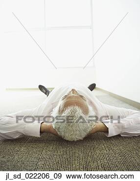 Stock Photograph - middle-aged businessman 
lying on office 
floor. fotosearch 
- search stock 
photos, pictures, 
images, and photo 
clipart