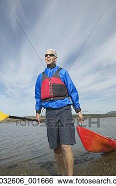 Stock Photo - middle-aged man 
pulling kayak 
out of the water, 
 california,  
united. fotosearch 
- search stock 
photos, pictures, 
images, and photo 
clipart