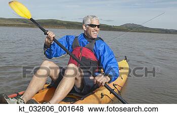 Stock Photo - middle-aged man 
rowing a kayak 
in still water, 
 california,  
united. fotosearch 
- search stock 
photos, pictures, 
images, and photo 
clipart