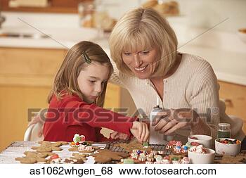 Stock Photo - mother and daughter 
decorating homemade 
gingerbread cookies. 
fotosearch - search 
stock photos, 
pictures, images, 
and photo clipart
