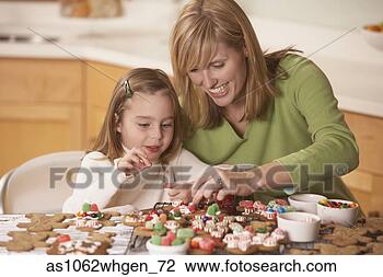 Stock Photo - mother and daughter 
decorating homemade 
gingerbread cookies. 
fotosearch - search 
stock photos, 
pictures, images, 
and photo clipart