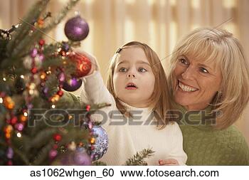 Stock Photography - mother and daughter 
putting an ornament 
on the christmas 
tree. fotosearch 
- search stock 
photos, pictures, 
images, and photo 
clipart
