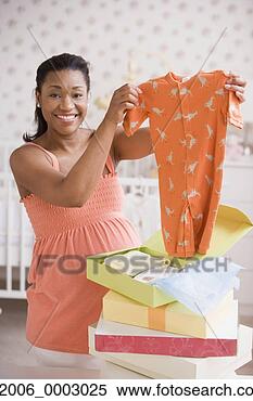 Stock Image - pregnant african 
mother opening 
gifts of baby 
clothes. fotosearch 
- search stock 
photos, pictures, 
images, and photo 
clipart