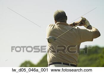 Stock Photography - rear view of man 
swinging a golf 
club, toronto, 
canada. fotosearch 
- search stock 
photos, pictures, 
images, and photo 
clipart