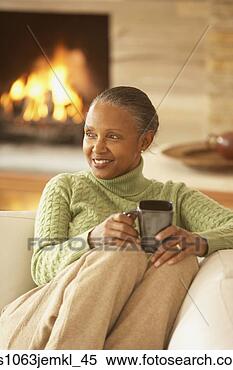 Stock Image - senior african 
woman sitting 
on the sofa,  
richmond,  virginia. 
fotosearch - search 
stock photos, 
pictures, images, 
and photo clipart