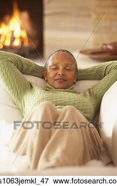Picture - senior african 
woman relaxing 
on the sofa,  
richmond,  virginia. 
fotosearch - search 
stock photos, 
pictures, images, 
and photo clipart