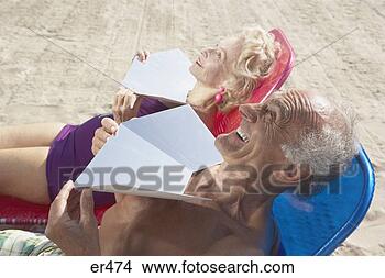 Stock Photo - senior couple 
sunning themselves 
at the beach. 
fotosearch - search 
stock photos, 
pictures, images, 
and photo clipart